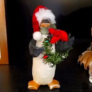 Penguin holding wreath